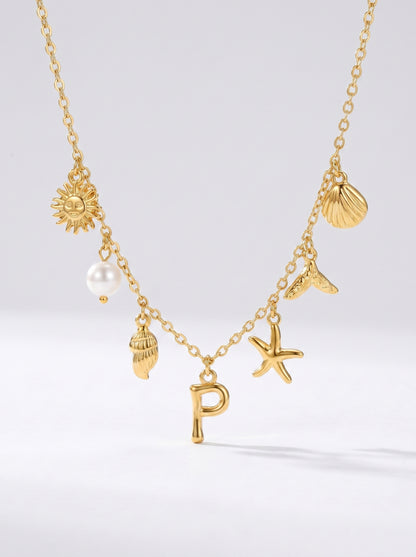 Colar dourado do mar com letra inicial P, estrela-do-mar, conchas, pérola e pendente de sol.
