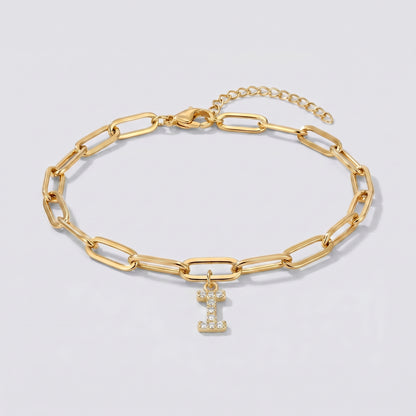 Pulseira dourada com letra inicial I, corrente paperclip e pendente de letra cravejado.