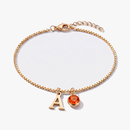 Pulseira letra A dourada com pedra de nascimento Julho — Rubi