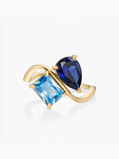 Anel duas pedras Setembro-Safira (pera) e Dezembro-Topázio Azul (retângulo) dourado