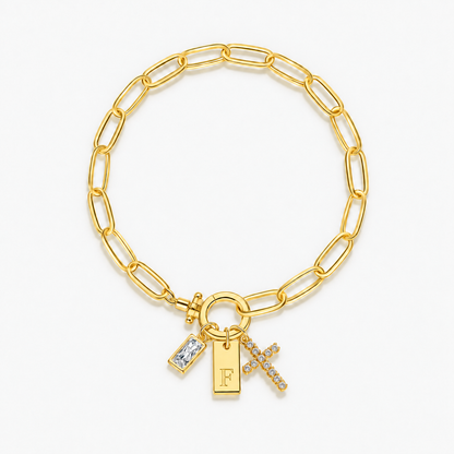 Pulseira dourada com inicial F e cruz