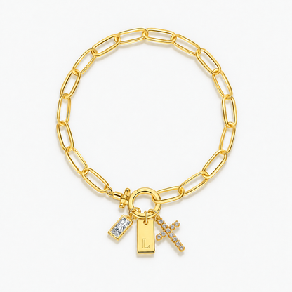 Pulseira dourada com inicial L e cruz