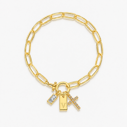 Pulseira dourada com inicial V e cruz