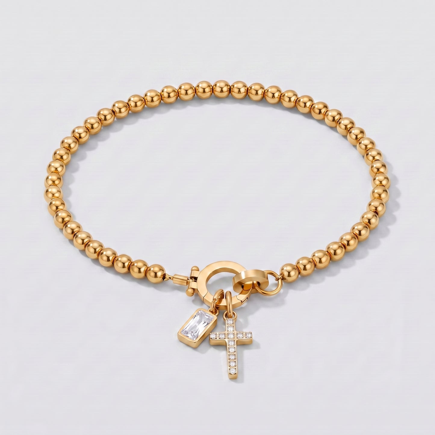 Pulseira dourada de contas com cruz e pedra de nascimento diamante transparente de abril.