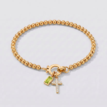 Pulseira dourada de contas com cruz e pedra de nascimento peridoto de agosto.