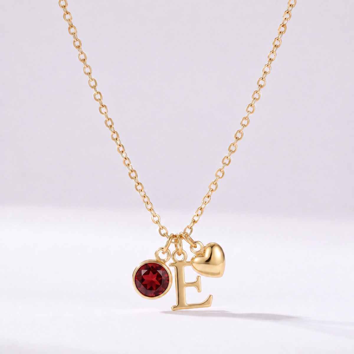 Colar letra E dourado com pedra de nascimento e coração