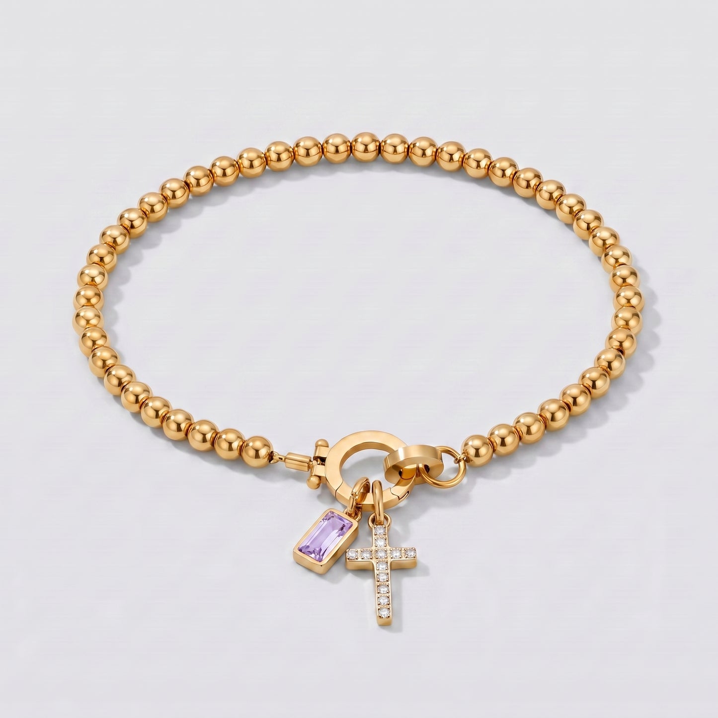 Pulseira dourada de contas com cruz e pedra de nascimento junho de alexandrite.