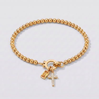 Pulseira prateada de contas com cruz e pedra de nascimento citrino amarelo de novembro.