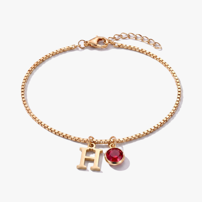 Pulseira letra H dourada com pedra de nascimento Janeiro — Granada