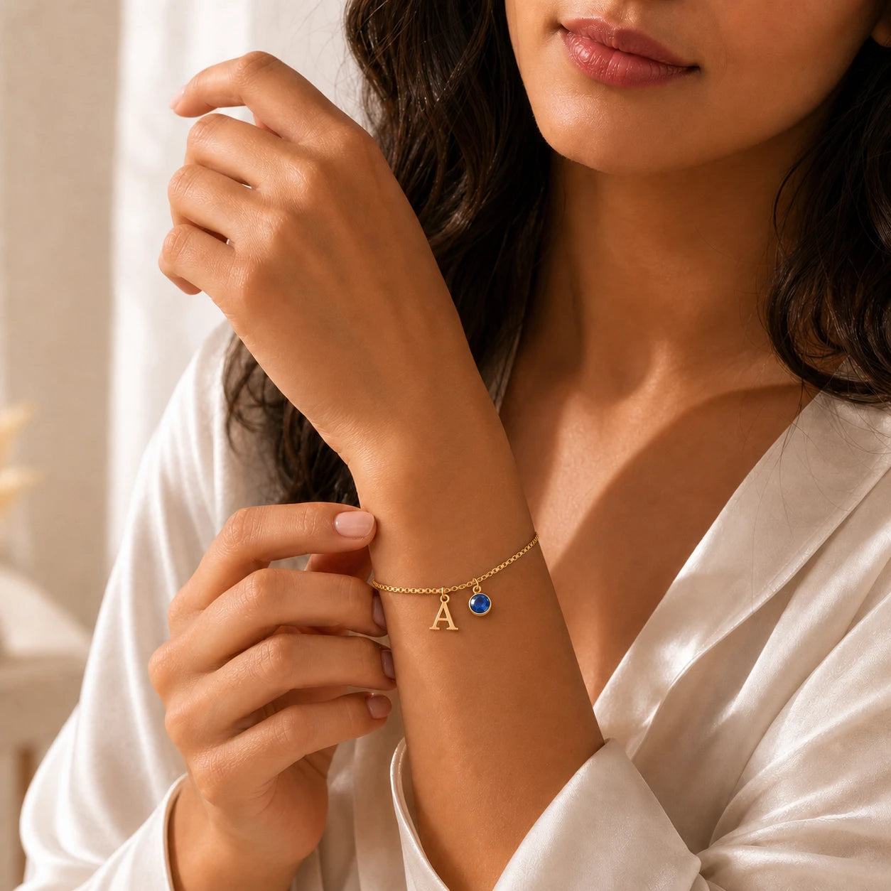 Pulseira letra A dourada no modelo — pedra Safira