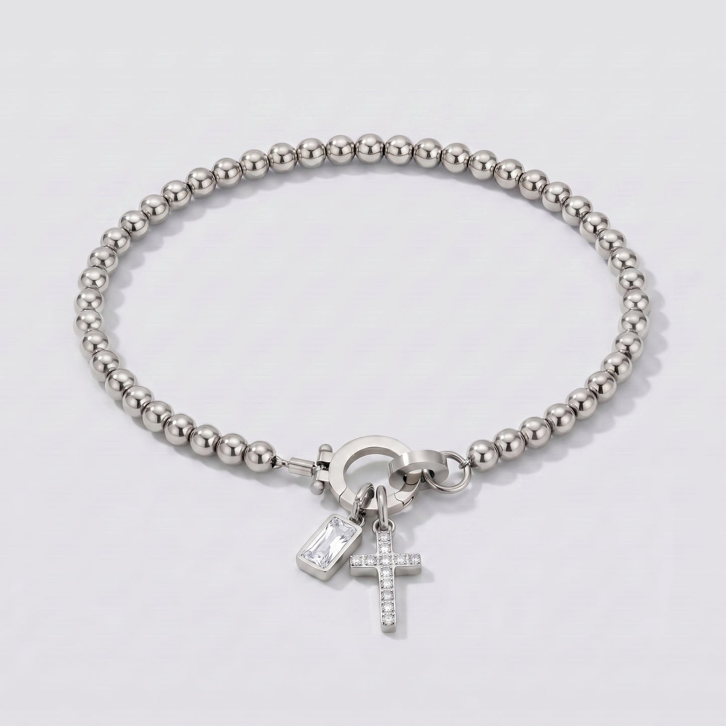 Pulseira prateada de contas com cruz e pedra de nascimento diamante transparente de abril.
