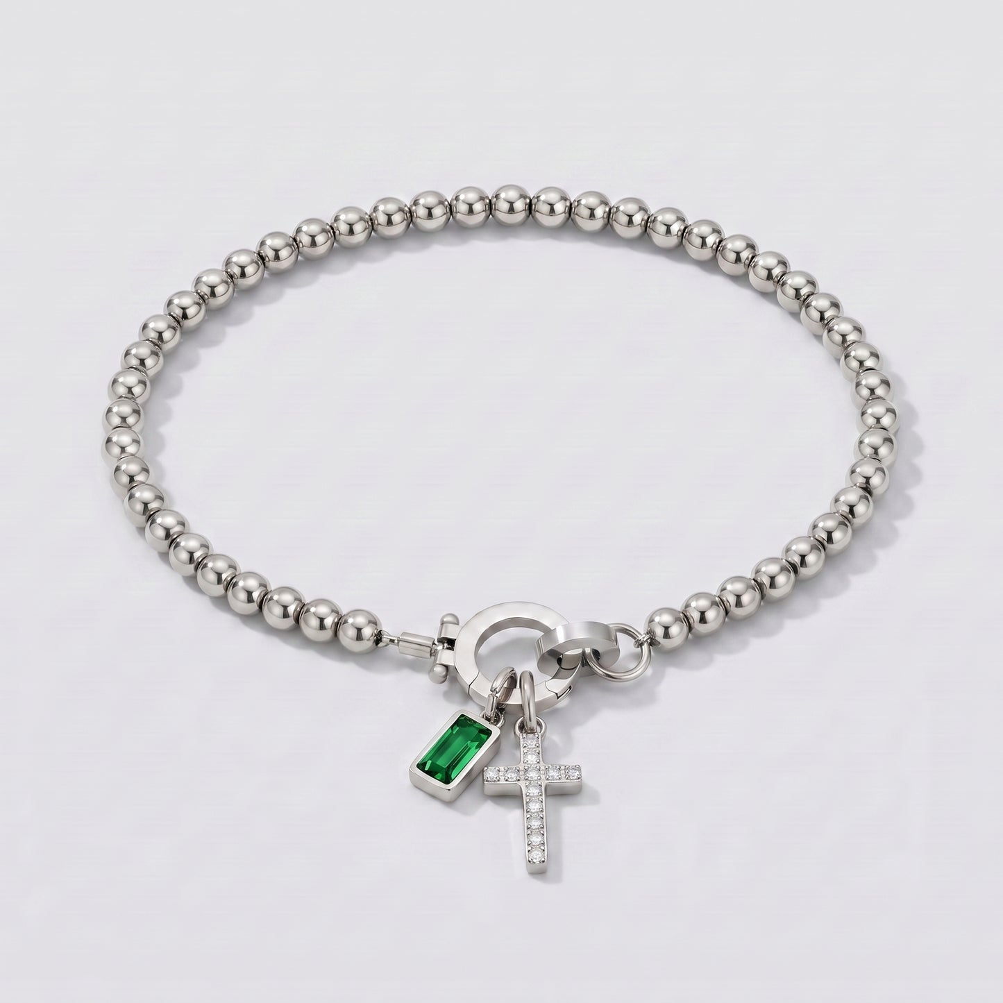 Pulseira prateada de contas com cruz e pedra de nascimento esmeralda verde de maio.