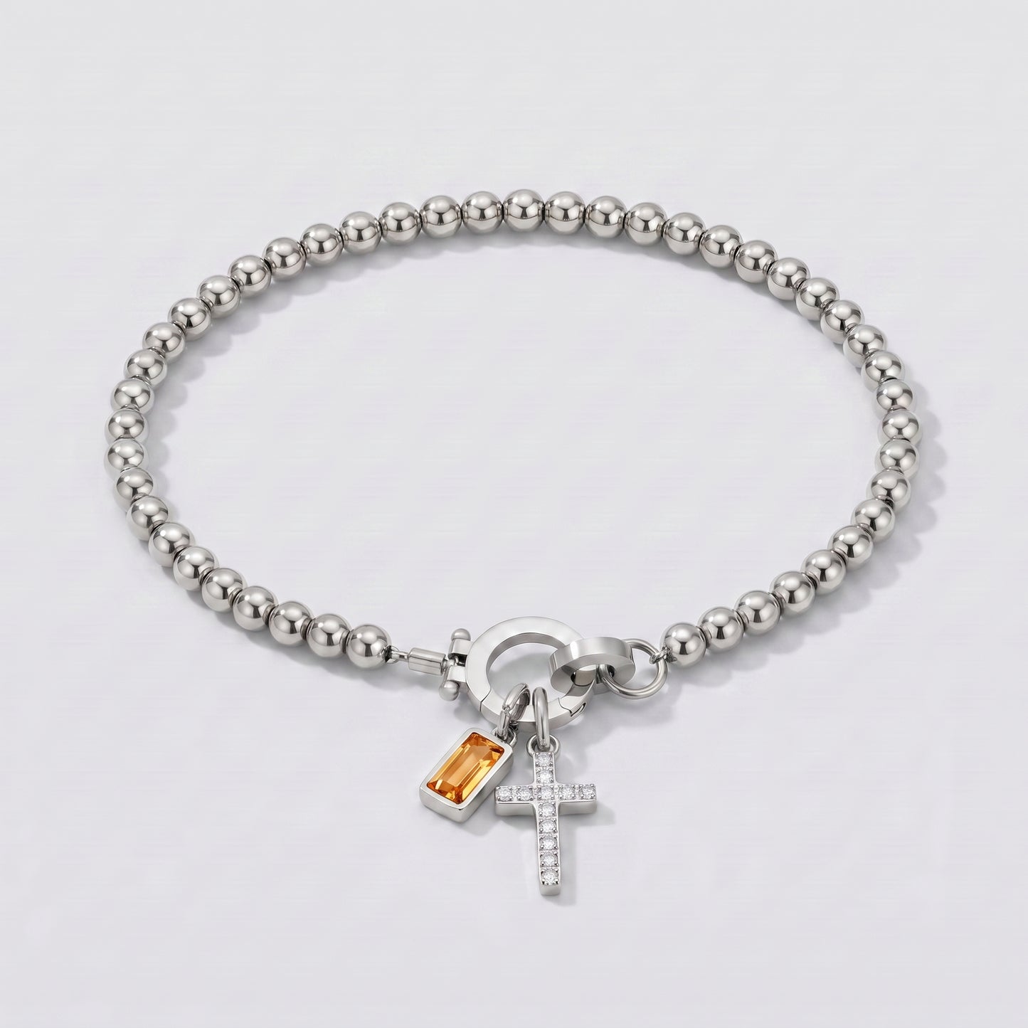 Pulseira prateada de contas com cruz e pedra de nascimento citrino amarelo de novembro.