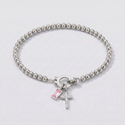 Pulseira prateada de contas com cruz e pedra de nascimento turmalina rosa de outubro.