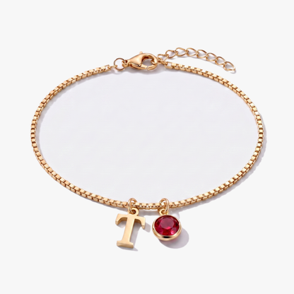 Pulseira letra T dourada com pedra de nascimento Janeiro — Granada
